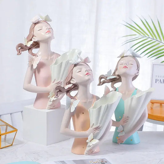 Three elegant resin butterfly girl figurines in pastel pink peach and teal dresses for flower vase decor