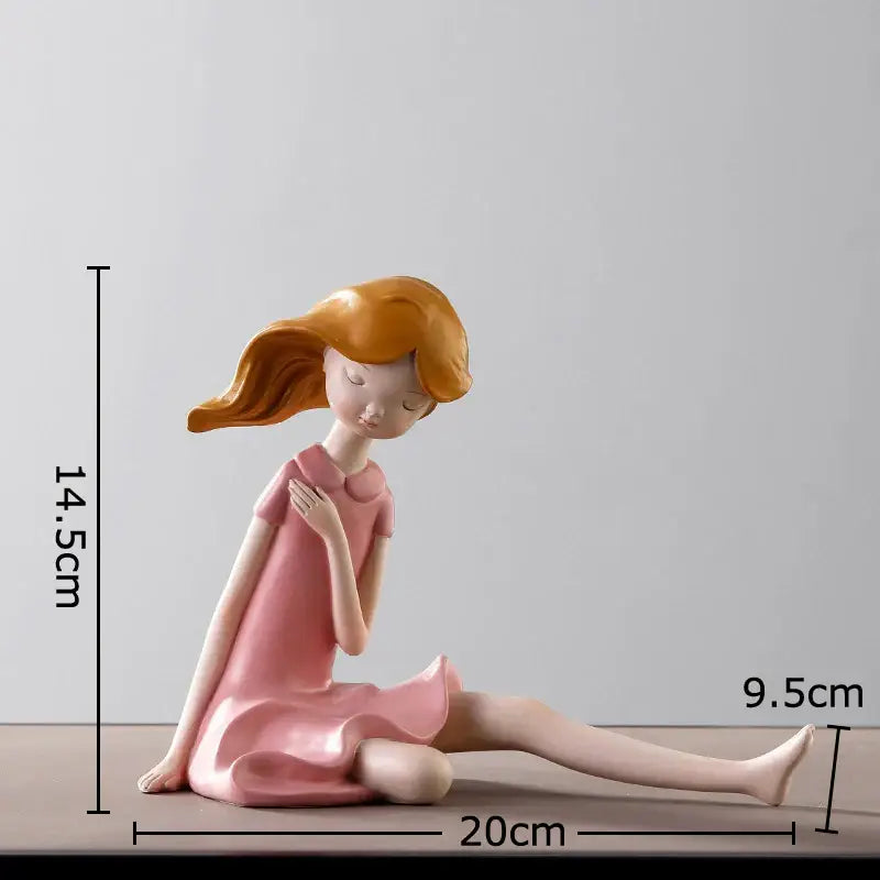 Pink resin cartoon girl sculpture with flowing orange hair sitting contemplatively for bedroom desk decorbites decor