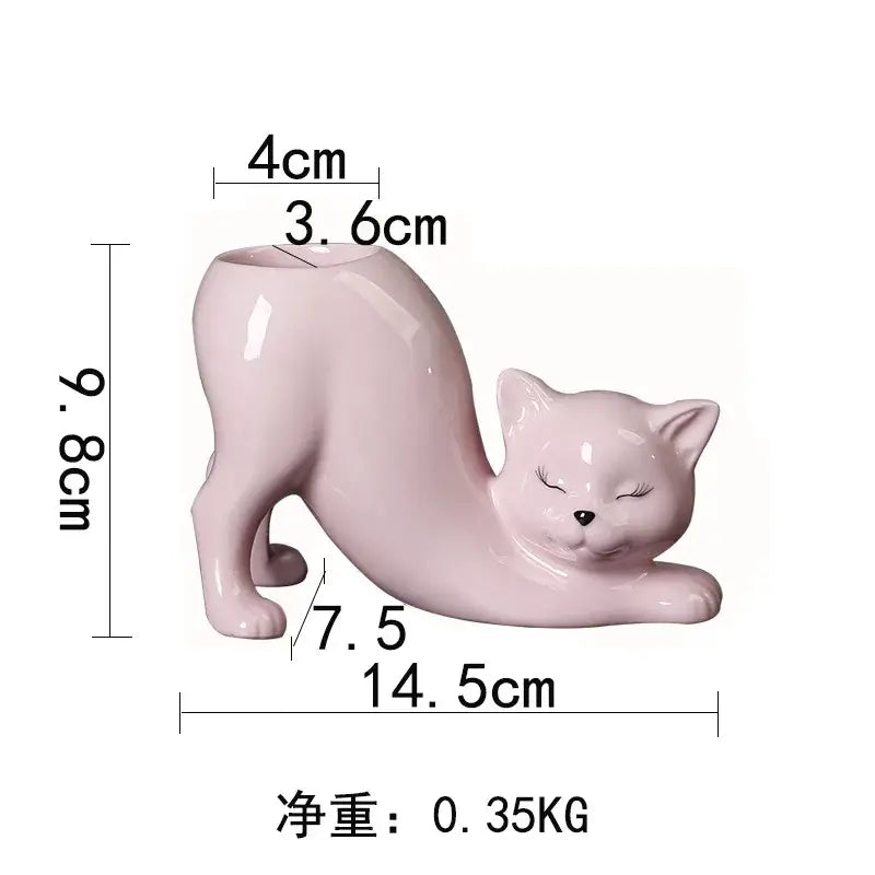A glossy pink ceramic cat tail succulent planter with a smooth curved body and closed eyes for bedroom decorbites cat tail decor