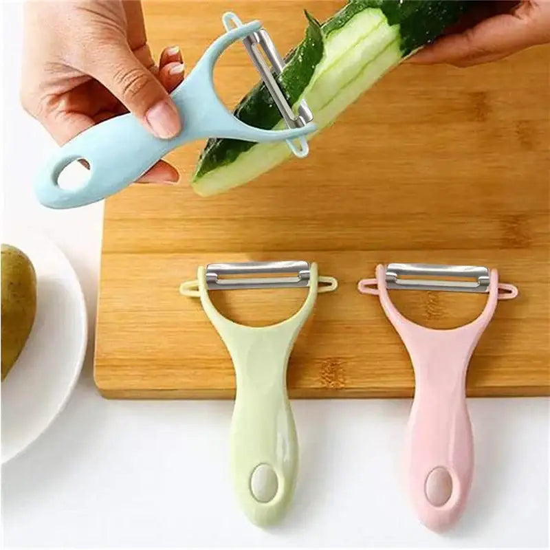 Light blue decorbites ceramic kitchen peeler with stainless steel blade peeling cucumber from pastel ceramic peeler set