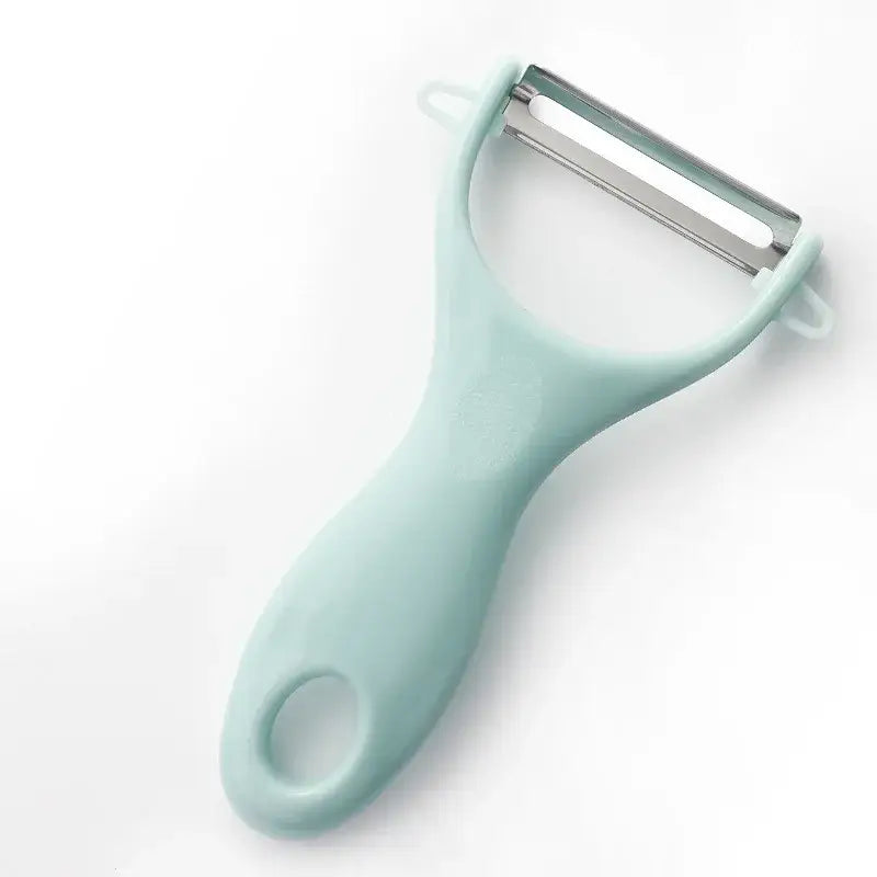 A mint green plastic-handled ceramic kitchen peeler with a stainless steel blade from decorbites ceramic kitchen set