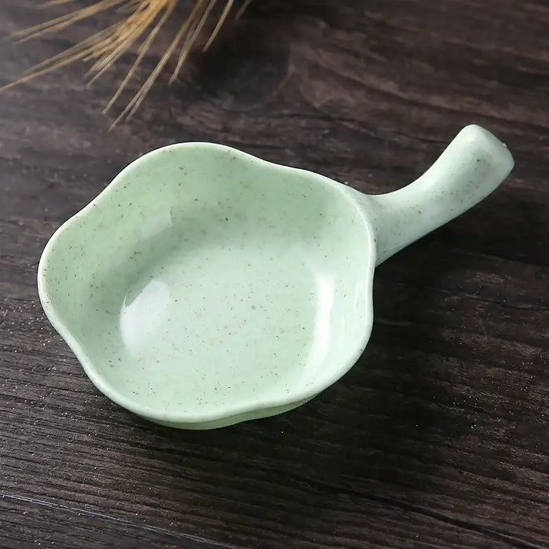 A pastel mint-green ceramic milk cup creamer with speckled glaze and small handle for decorbites ceramic milk use