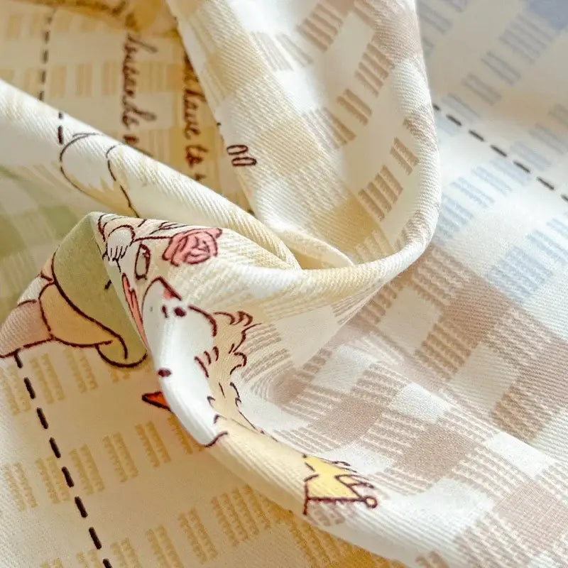 A soft cream-colored silk scarf with cartoon and script pattern complements pastel checkered cotton printed student bedding set decorbites cotton printed decor