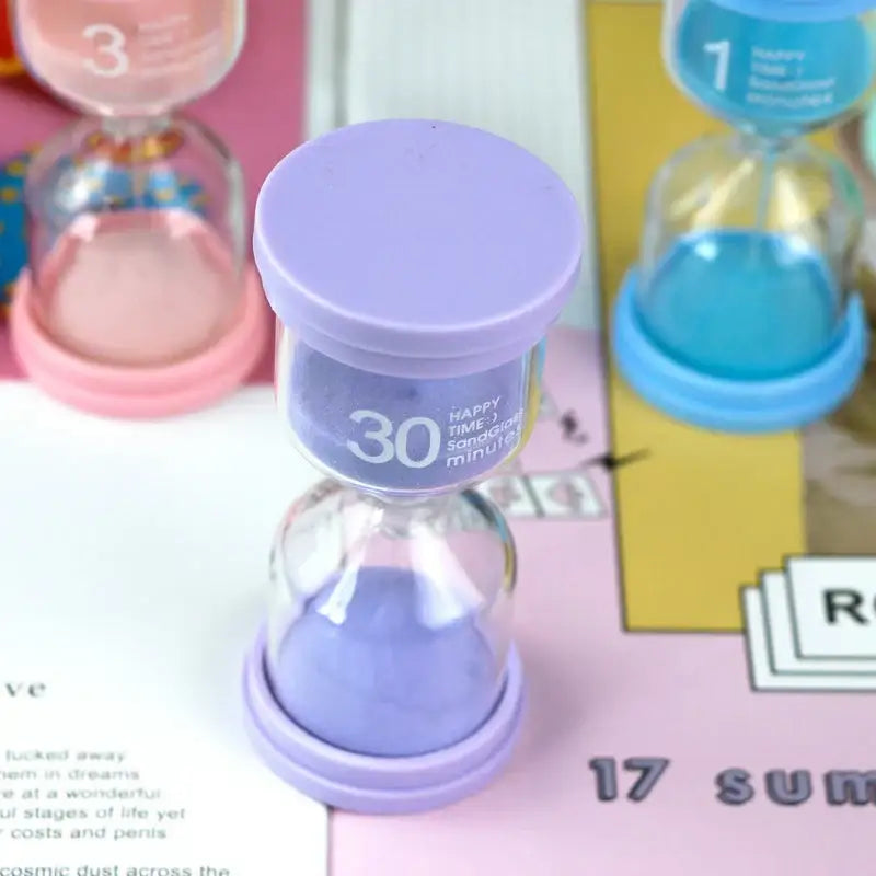 Purple 30-minute sand timer with lavender sand and smooth plastic base in pastel colorful decorbites hourglass sand set for kids bedroom