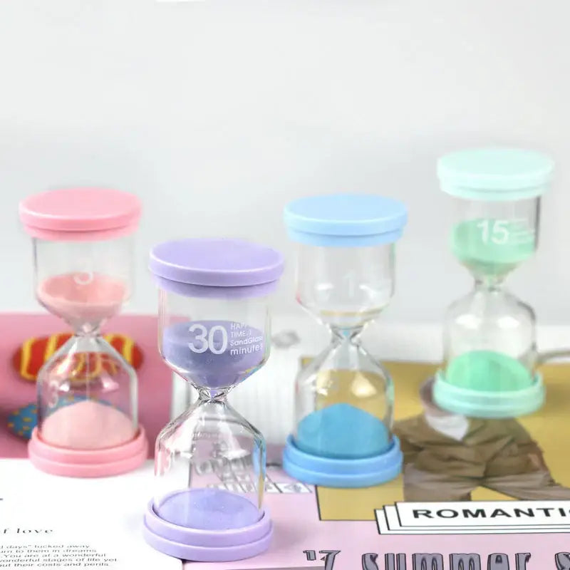 A set of four pastel colorful glass hourglass sand timers with plastic bases marked with different time intervals for kids bedroom decorbites hourglass sand timer