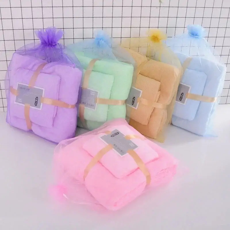 Pastel coral velvet bath towel set wrapped in sheer mesh bags with gold ribbons for soft absorbent velvet bath linens
