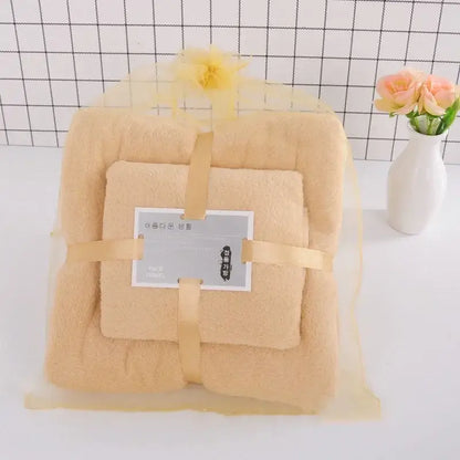 Beige plush pastel coral velvet bath towel set wrapped in yellow mesh with ribbon and decorative flower for soft absorbent linens