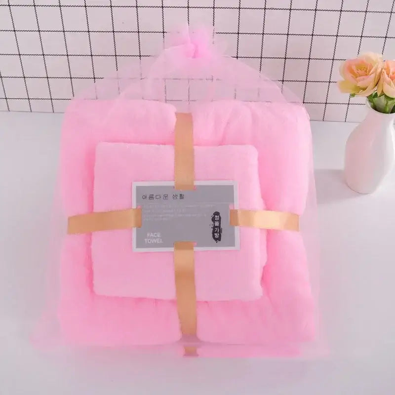 Pink plush coral velvet bath towel set wrapped in sheer mesh with gold ribbon for soft absorbent linens decorbites coral velvet