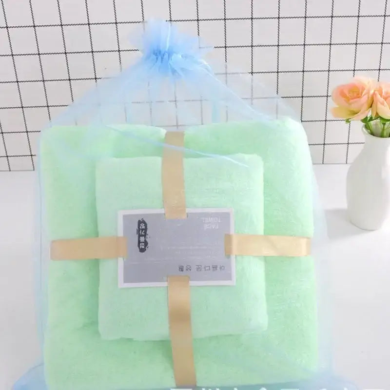 Pastel coral velvet bath towel set in soft mint green wrapped in sheer blue organza bag with gold ribbon decorbites coral velvet