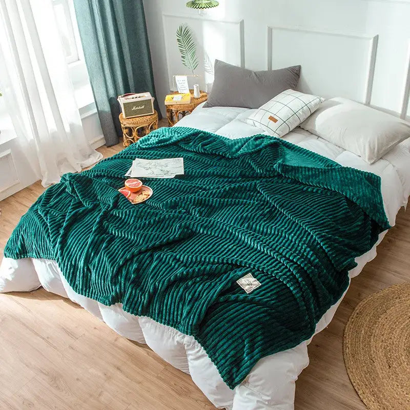Emerald green corduroy cozy hug blanket with plush ribbed texture and subtle woven label for soft sweatshirt throw decorbites