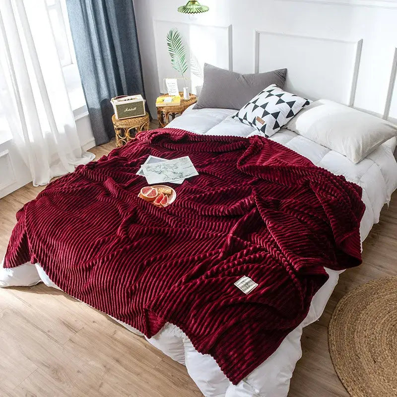 A plush deep red corduroy cozy hug blanket with ribbed texture and woven label for decorbites soft sweatshirt throw