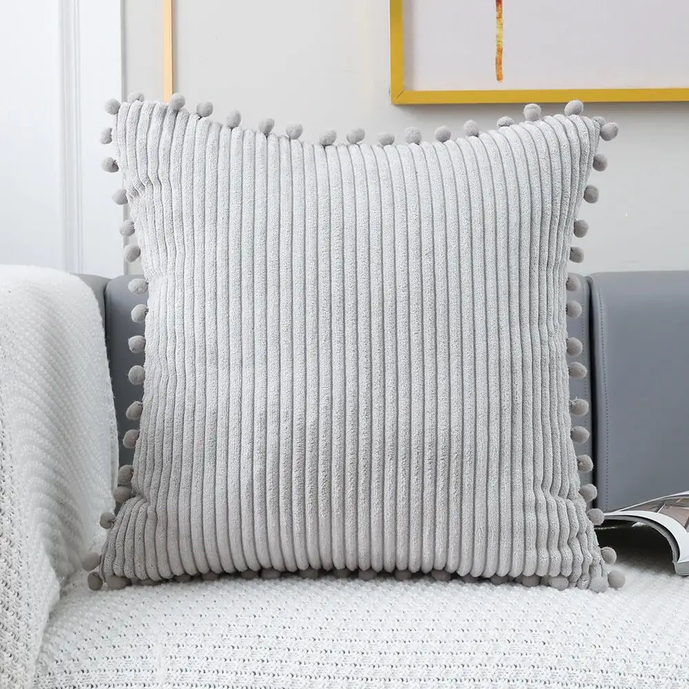 Gray corduroy pompom cushion cover with soft vertical ridges and matching pom-poms for living room decorbites decor