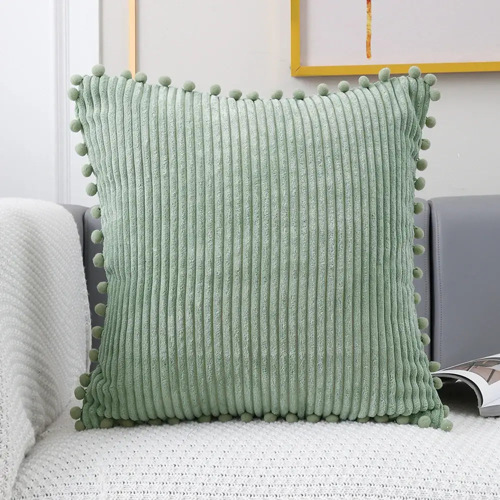 A soft mint green corduroy pompom cushion cover with vertical ribbed texture for living room decorbites decor