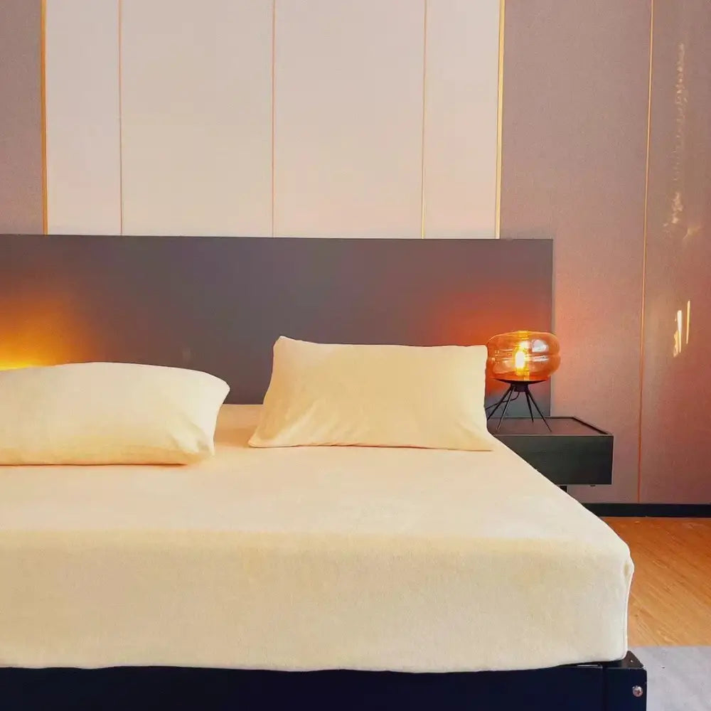 Cream-colored decorbites cozy flannel queen bed sheet with a smooth textured surface draped on a plush mattress cover