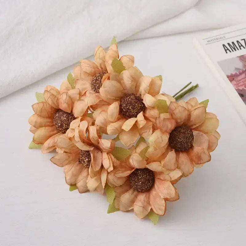 A decorbites daisy sunflower bouquet featuring peach artificial sunflowers with textured brown centers and green fabric leaves for wedding room decor