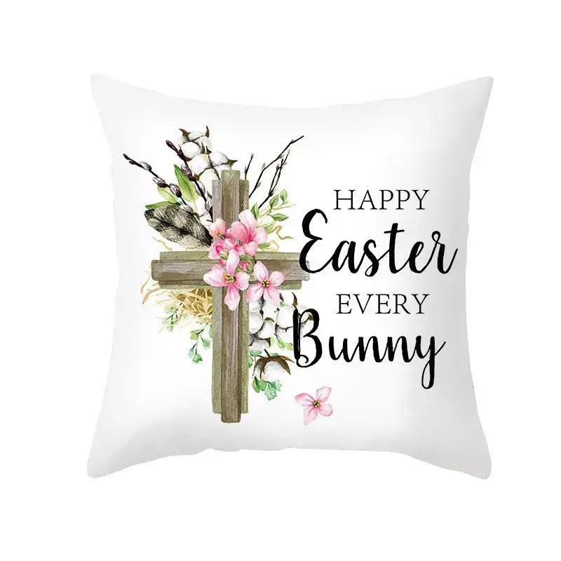 White throw pillow cover with rustic wooden cross, pink flowers, greenery, and easter egg bunny spring decor text