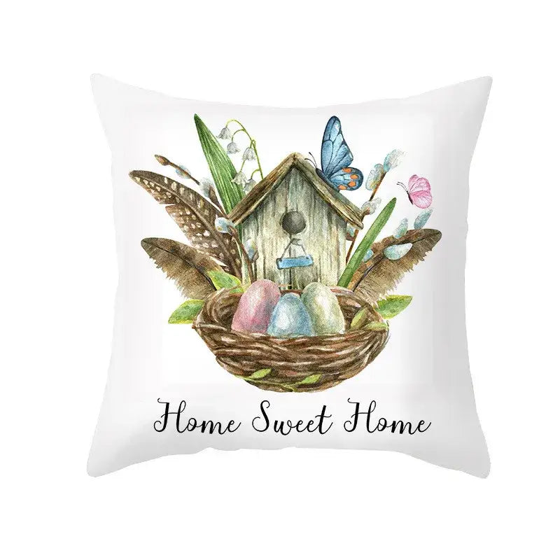 White throw pillow cover with pastel easter egg bunny design featuring a rustic birdhouse and home sweet home text