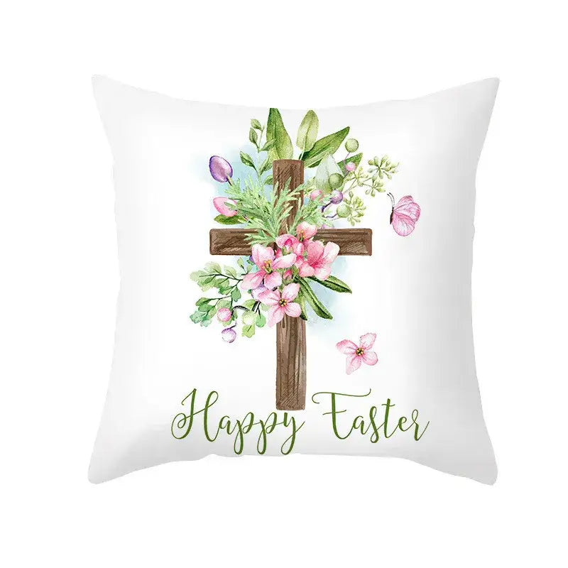 White throw pillow cover with wooden cross, pink flowers, butterflies, and happy easter script for spring decor