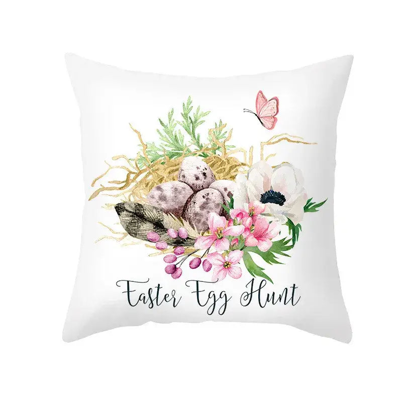 White throw pillow cover featuring pastel easter egg bunny design with nest pink flowers and butterfly for spring decor