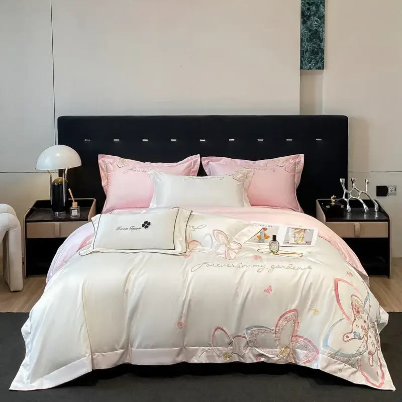 Ivory satin bedding set with soft pink and gold decorbites embroidered butterfly flowers and romantic script design