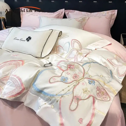 Luxurious satin bedding set with decorbites embroidered butterfly flowers in pastel pink blue and gold on creamy white
