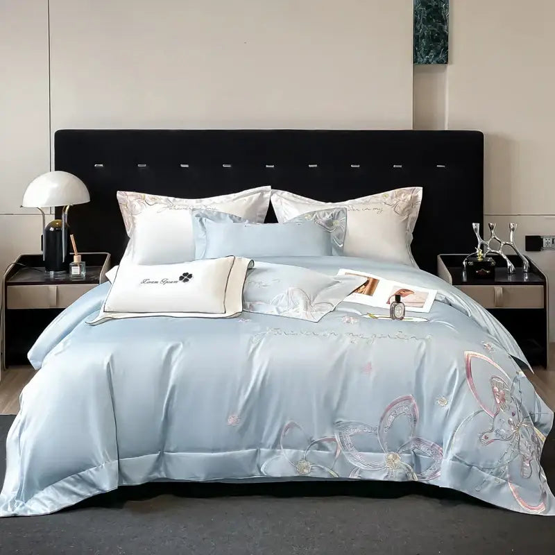 Light blue satin bedding set featuring decorbites embroidered butterfly flowers for elegant bedroom decor