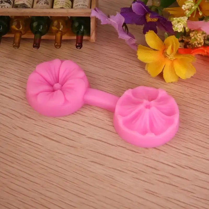 Pink silicone five petals flower mold with two circular petals connected by a short handle for baking use