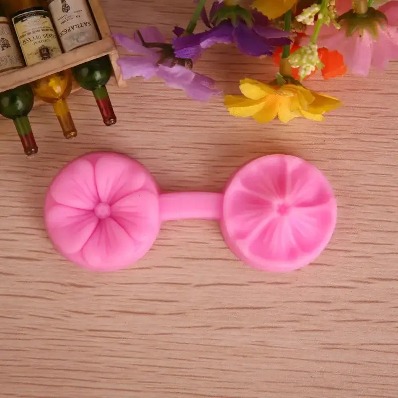 Pink silicone five petals flower mold with two circular petals connected by a central handle for kitchen baking tools