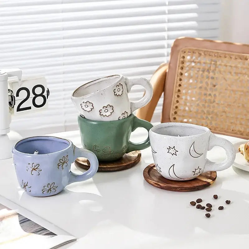 Set of three ceramic cartoon animal coffee mugs in pastel blue sage green and off-white with floral and celestial decorbites 3d cartoon motifs