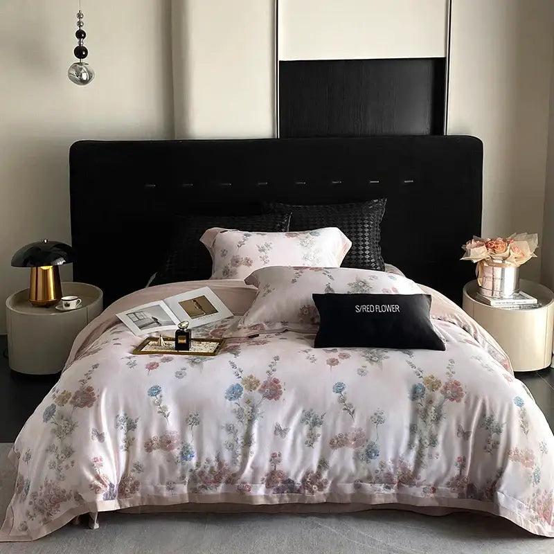 A soft pink satin bedding set with decorbites flowers prints featuring delicate pastel blossoms and butterflies