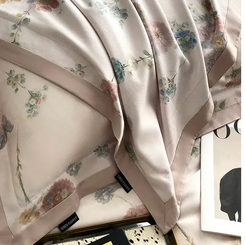 A soft blush-pink silk scarf with delicate decorbites flowers prints complements the pastel floral flowers prints bedding set