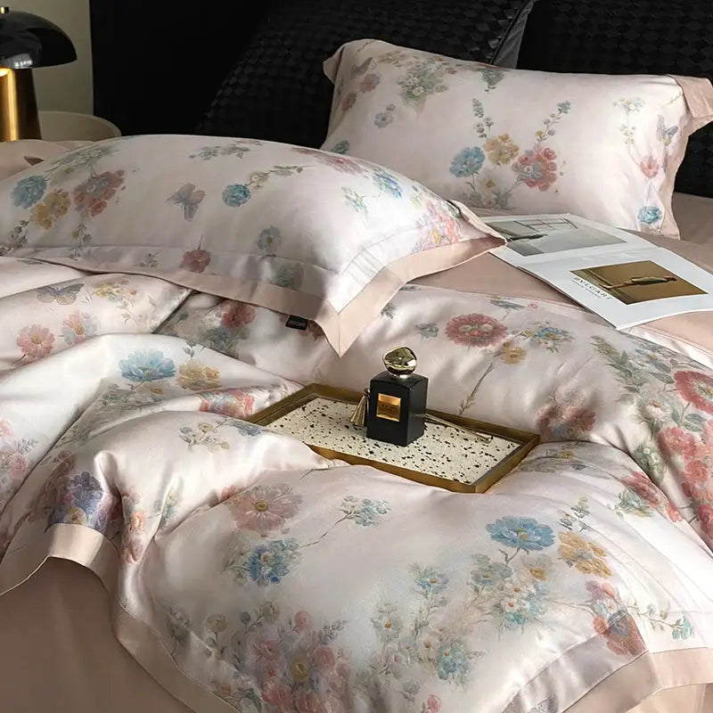 Delicate pink satin bedding set featuring decorbites flowers prints with pastel blossoms and butterflies in soft hues