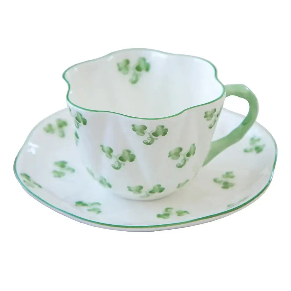 Delicate white porcelain coffee cup and saucer set with green shamrocks and rims by decorbites bone for dining room