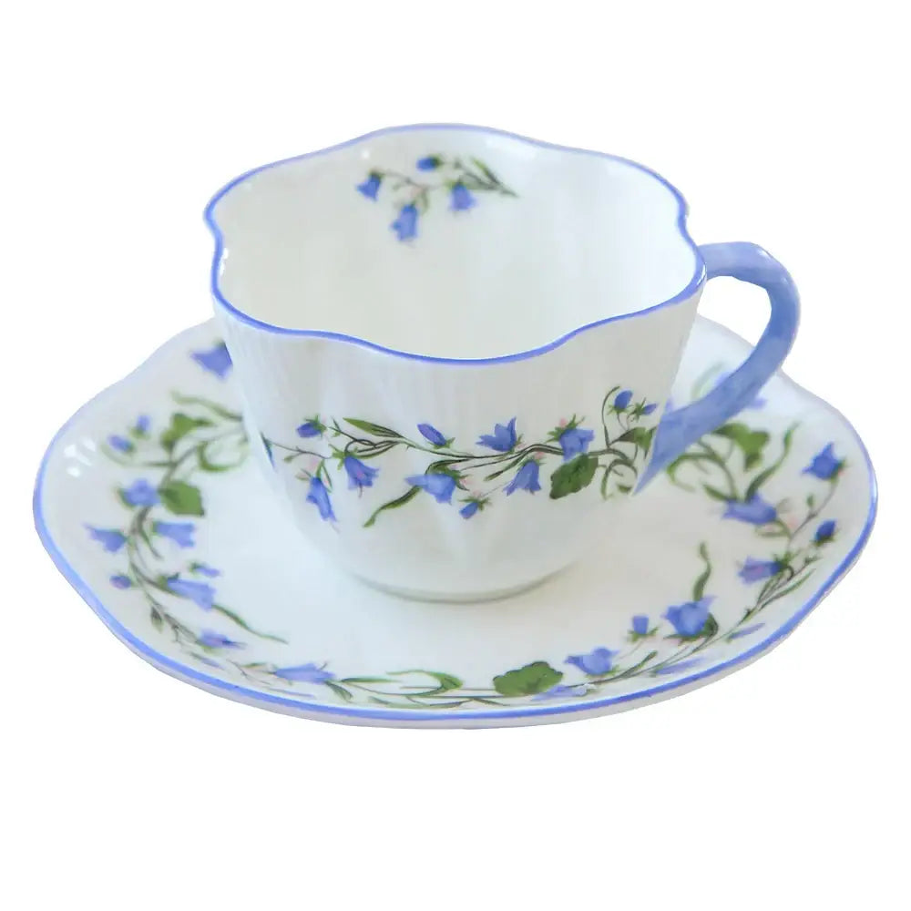 Delicate white porcelain decorbites bone coffee cup and saucer set with blue bellflower pattern and scalloped edges