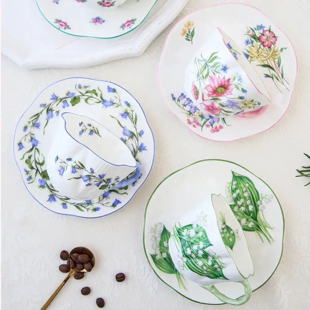 White porcelain decorbites bone coffee cup and saucer set with pastel floral hand-painted design and scalloped edges