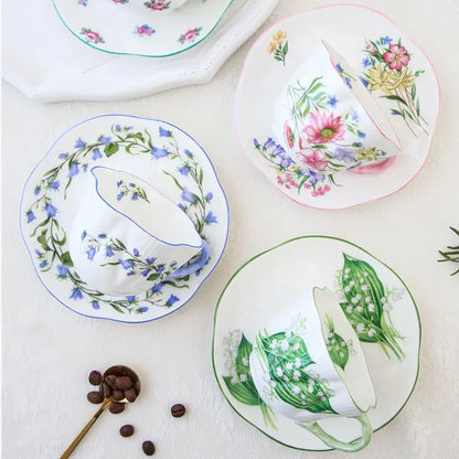 White porcelain decorbites bone coffee cup and saucer set with pastel floral hand-painted design and scalloped edges
