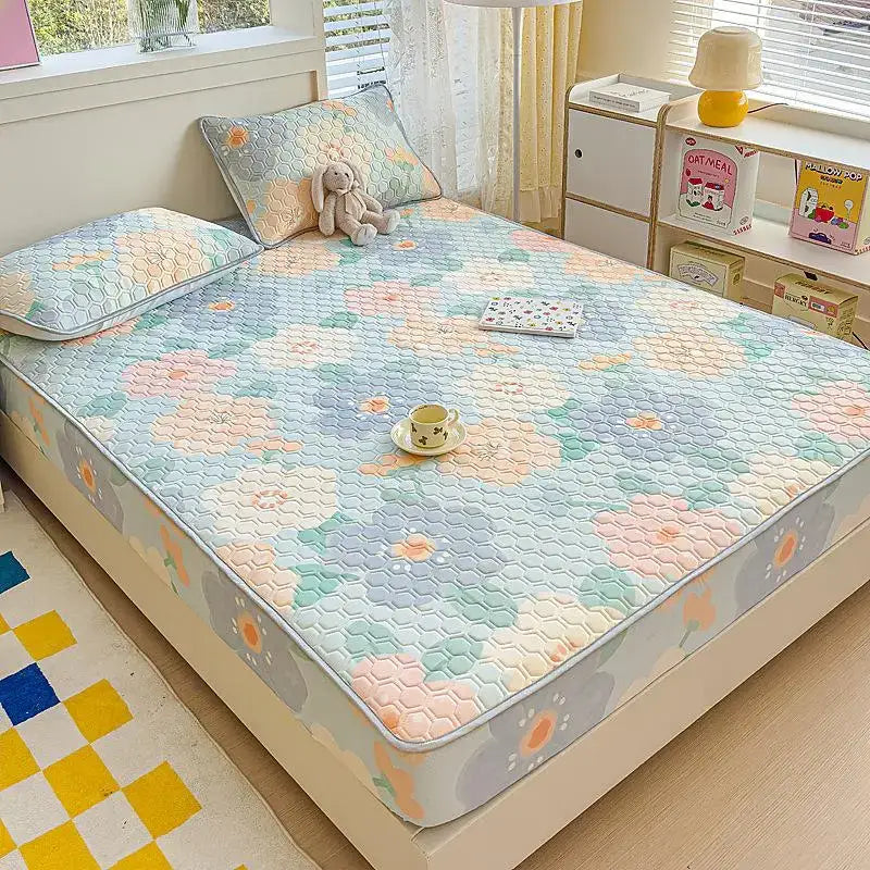 Pastel floral quilted latex fitted sheet set with hexagonal stitching in soft blue pink and green tones bedroom bed pad