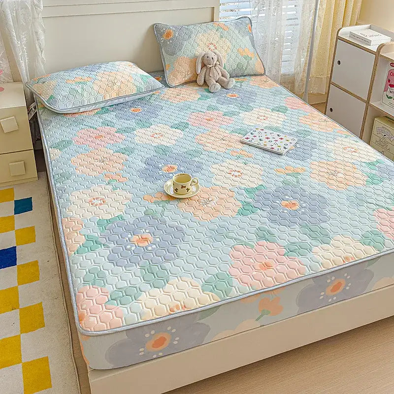 Pastel floral quilted latex fitted sheet set with hexagonal stitching in soft blue pink and green tones bed pad
