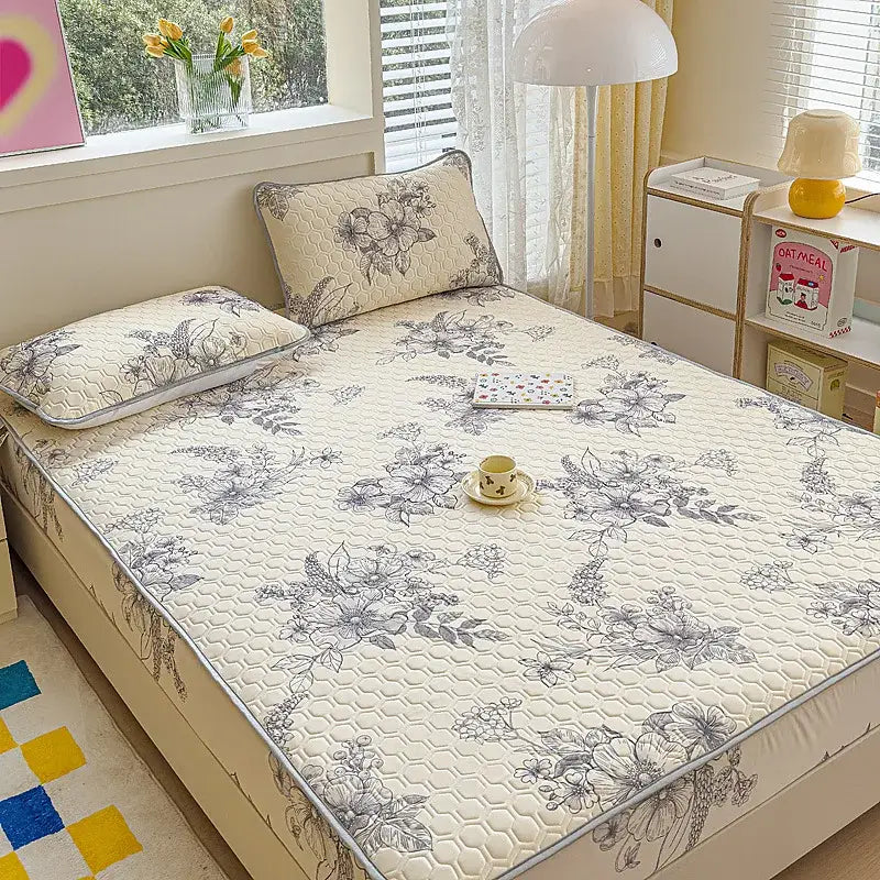 Beige quilted latex fitted sheet set with gray floral embroidery and subtle hexagonal texture for bedroom bed pad