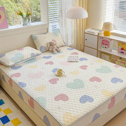Pastel floral quilted latex fitted sheet set featuring a heart-patterned, soft textured bed pad with gentle stitching