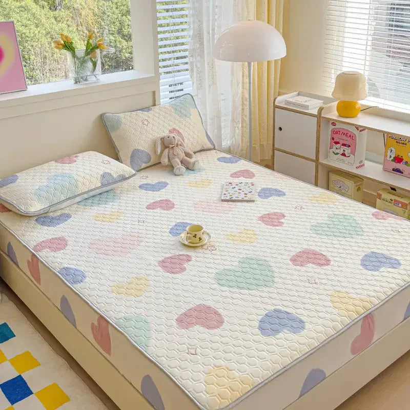 Pastel floral quilted latex fitted sheet set featuring a heart-patterned, soft textured bed pad with gentle stitching