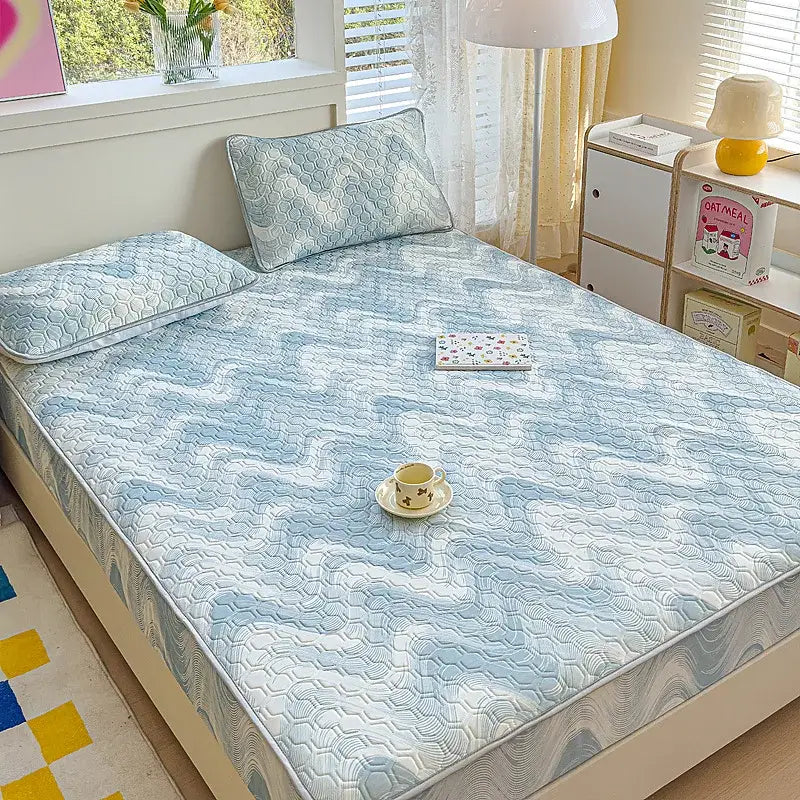 Light blue quilted latex fitted sheet set with subtle hexagonal pattern and matching pillow for bedroom use