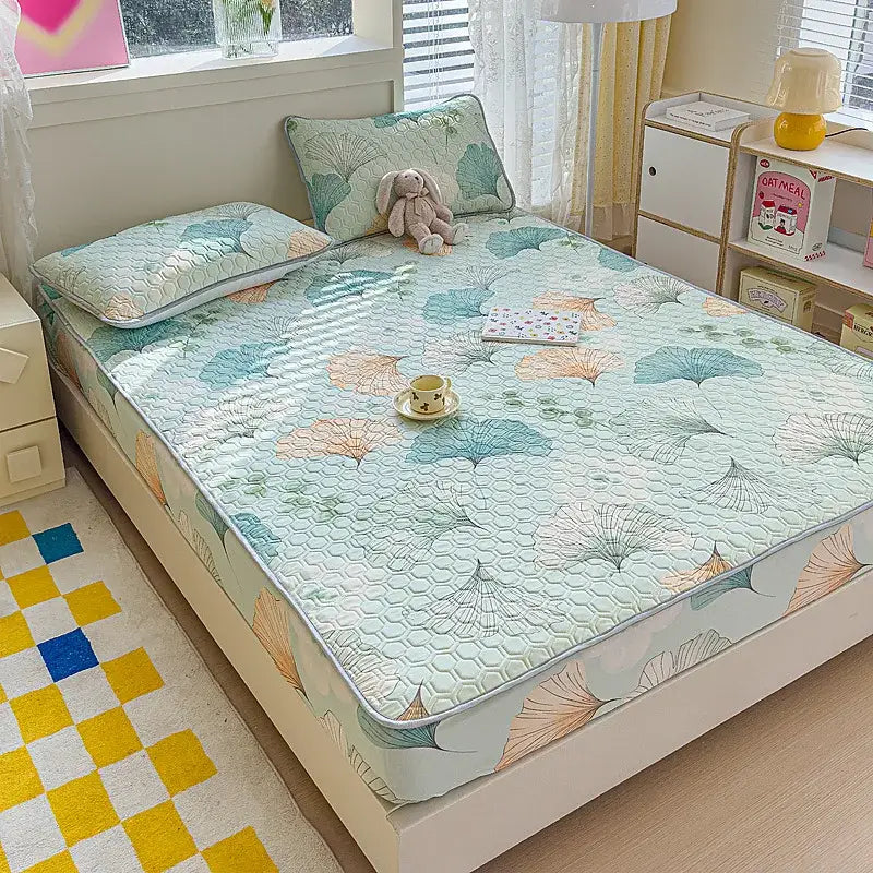 Pastel floral quilted latex fitted sheet set with soft mint green base and delicate teal and peach leaf patterns