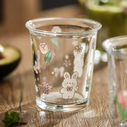 Clear glass tumbler with pastel floral and rabbit illustrations ideal for glass tea coffee use in kitchen settings