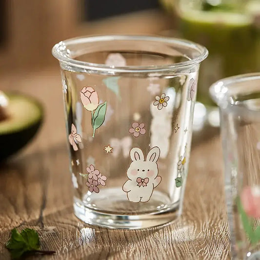 Clear glass tumbler with pastel floral and rabbit illustrations ideal for glass tea coffee use in kitchen settings