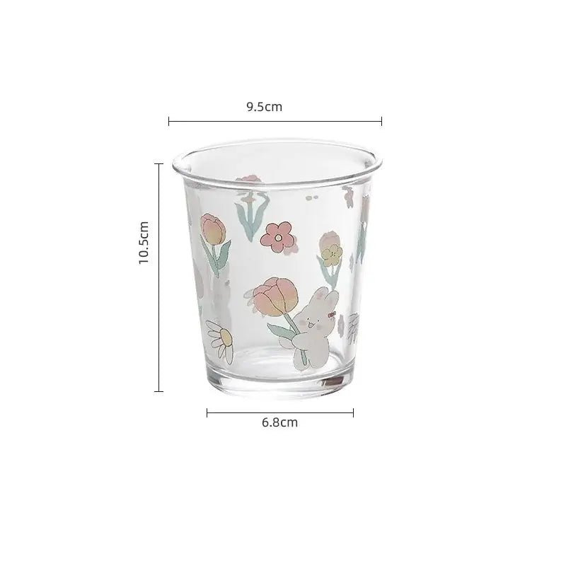 Clear glass tea coffee cup with pastel floral rabbit design featuring a white bunny holding tulips for kitchen use