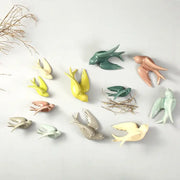 Pastel flying bird ceramic wall ornaments in green yellow pink and beige bird ceramic wall decor for living room