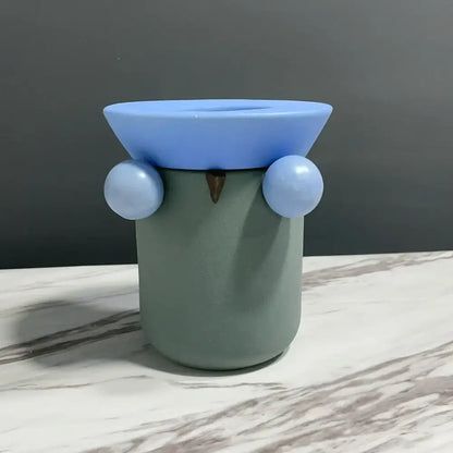 A mint green ceramic geometric ball owl tissue box with light blue eyes and matching lid for decorbites geometric ball decor