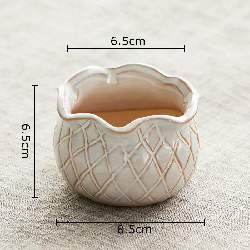 A small off-white lotus flower ceramic planter with scalloped rim and diamond texture for decorbites bedroom decor