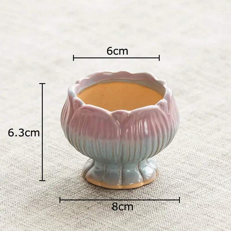 A lotus flower ceramic planter with pastel pink to light blue gradient glaze and subtle ridges for decorbites lotus flower decor